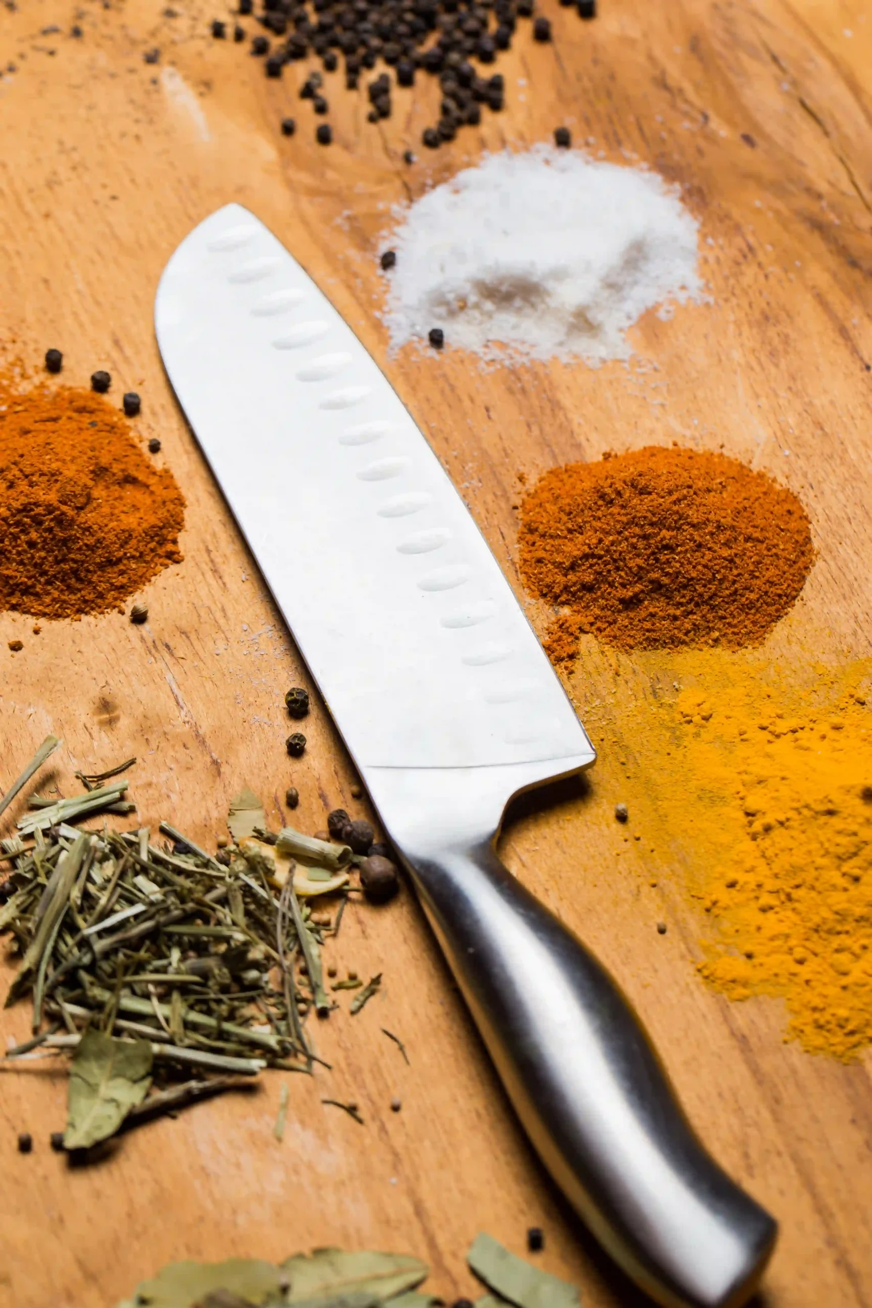 knife-and-assorted-spices-on-wood-surface-2026-03-25-08-25-02-utc
