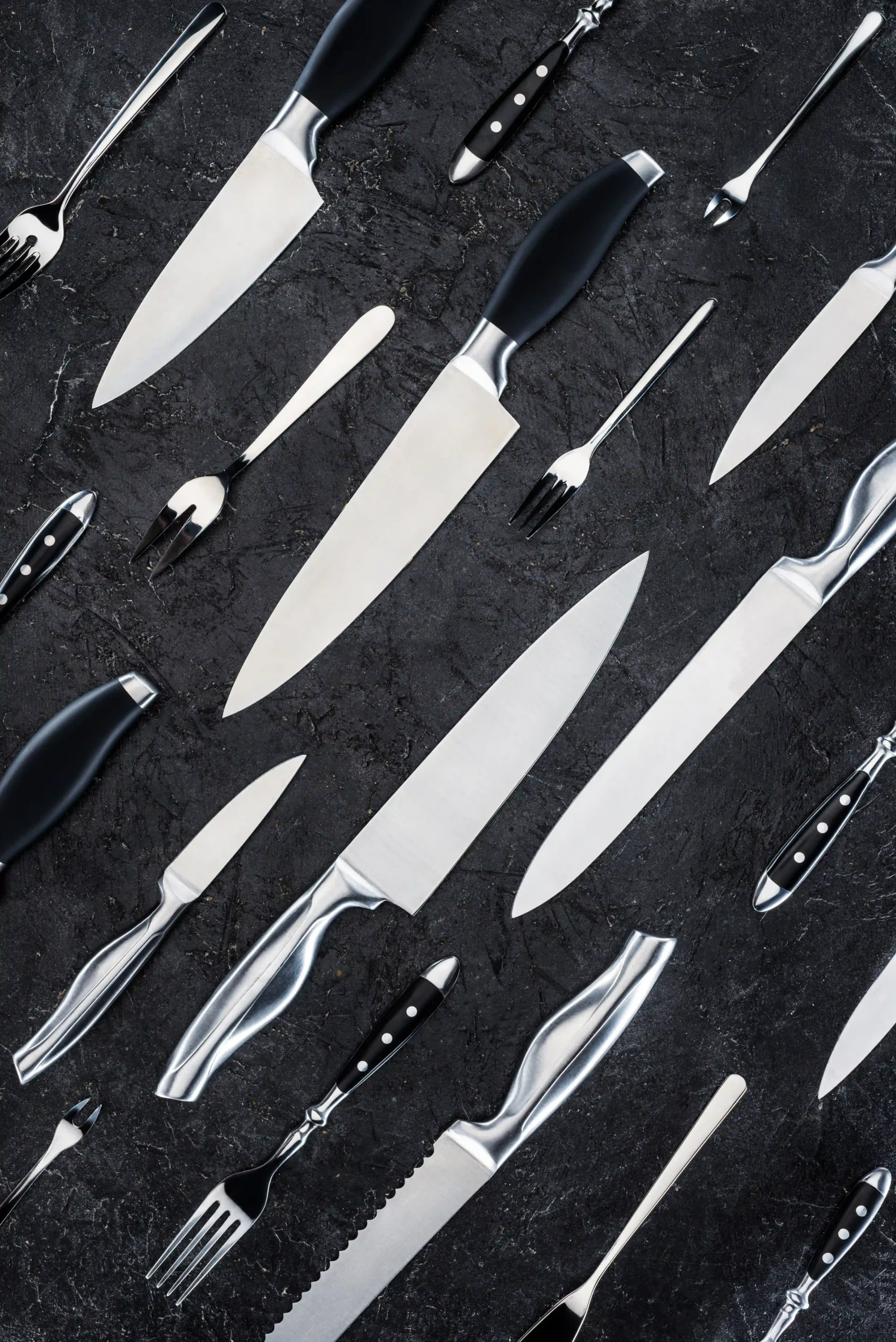 top-view-of-various-forks-and-knives-on-black-surf-2026-03-11-08-38-20-utc